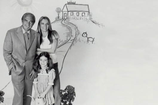 family standing infront of drawing of a house