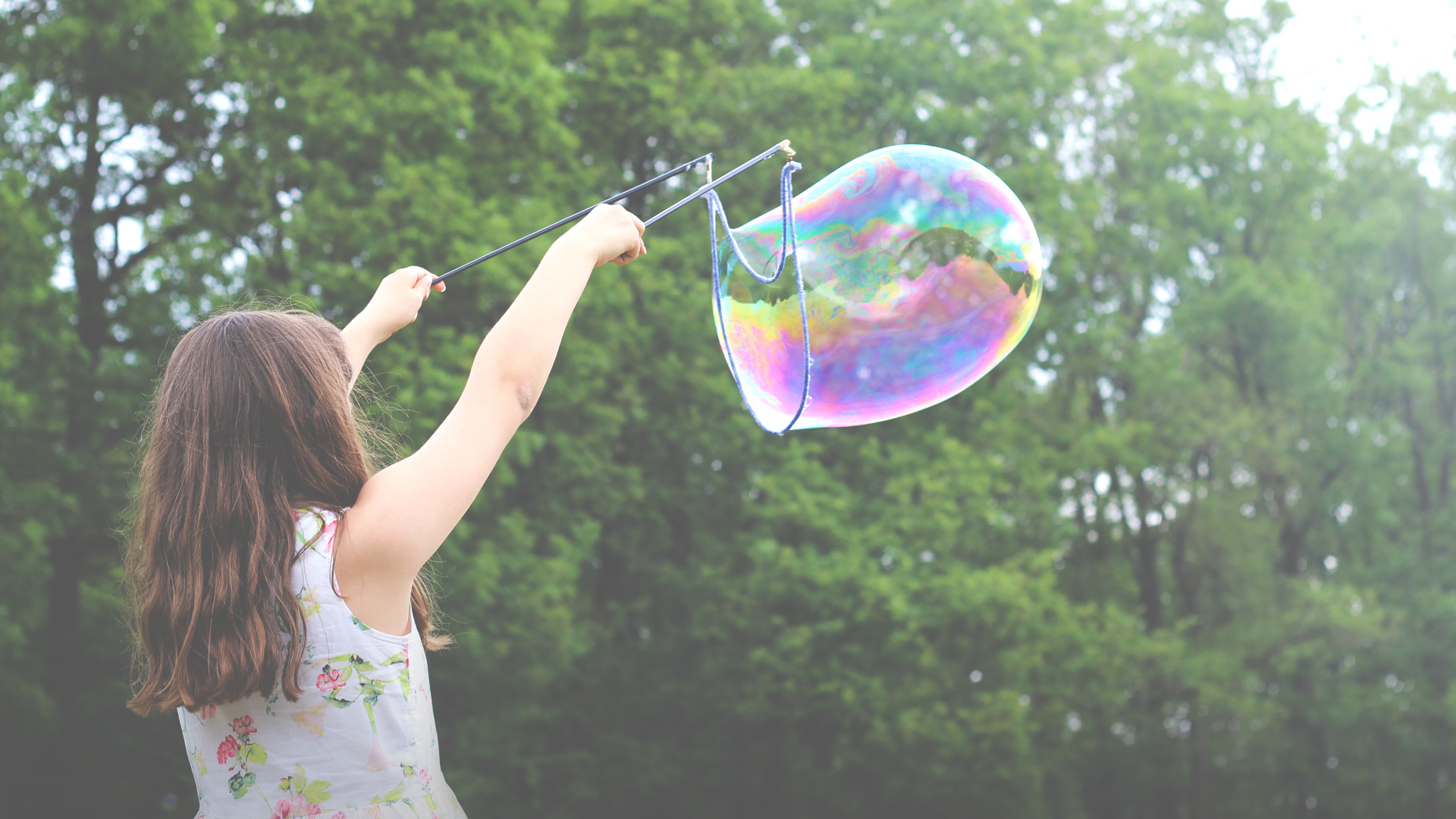 Young girl making a giant bubble