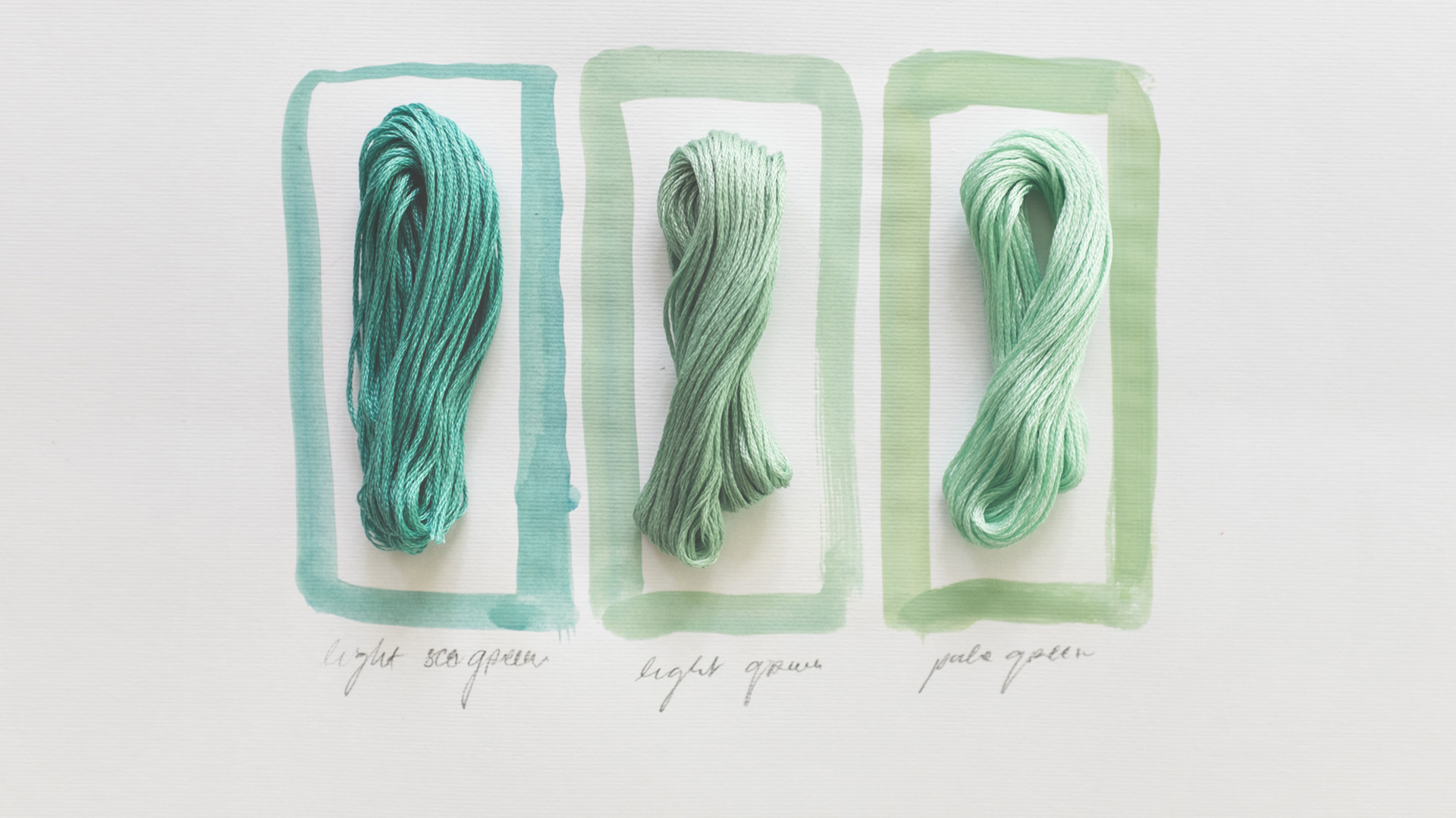 Three different colored pieces of yarn